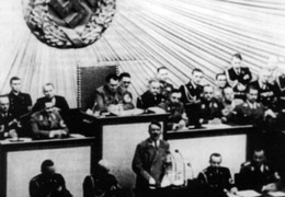 Hitler speaks before the Reichstag.